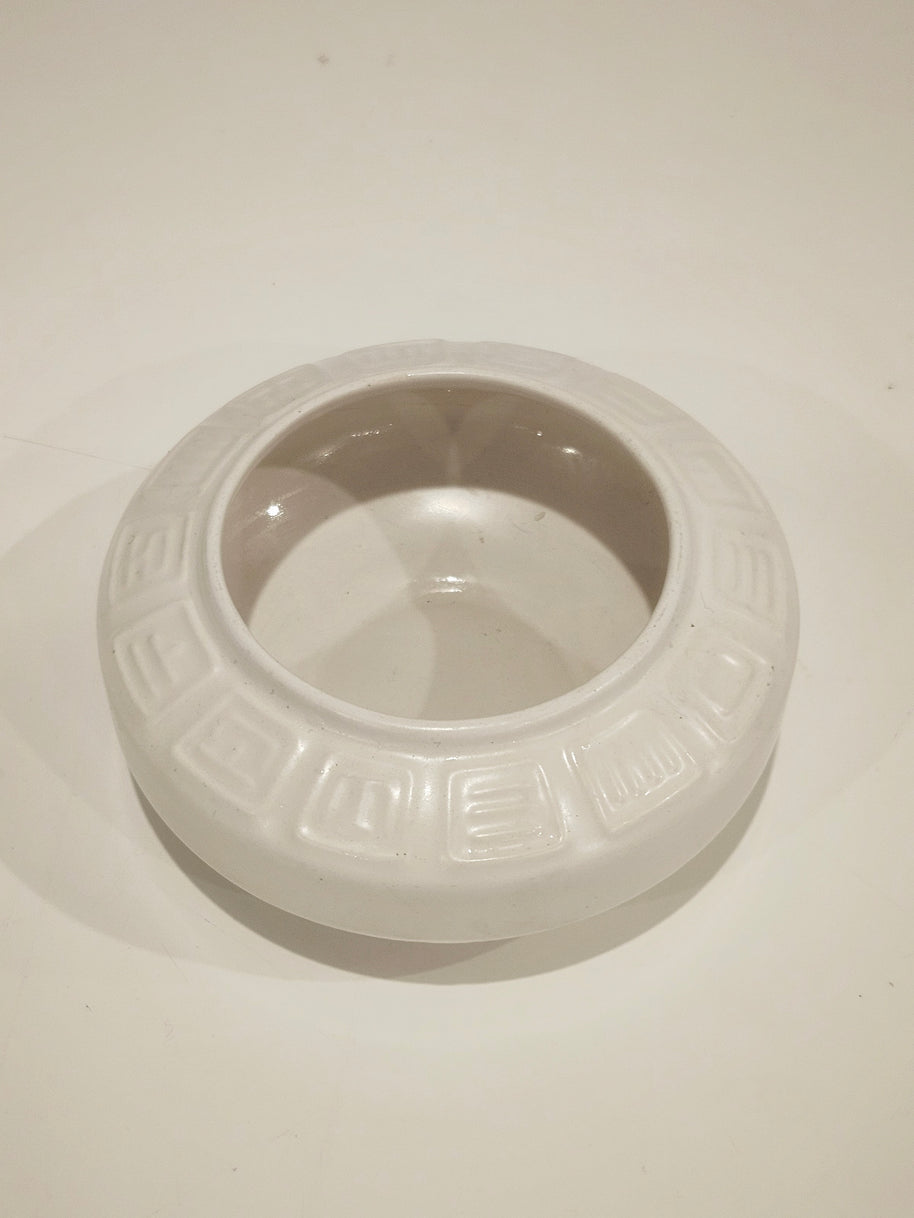 Round ikebana pottery vase arrangement