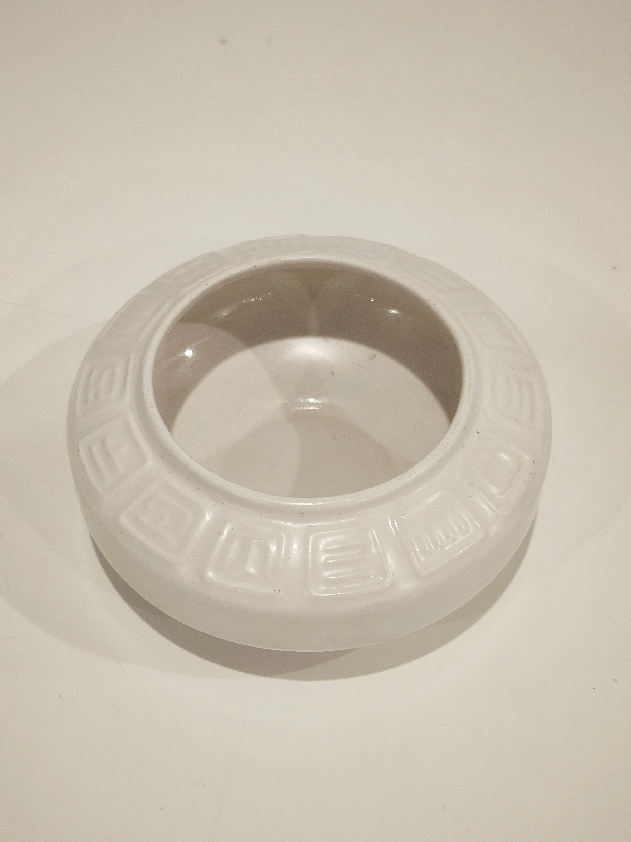 Round ikebana pottery vase arrangement