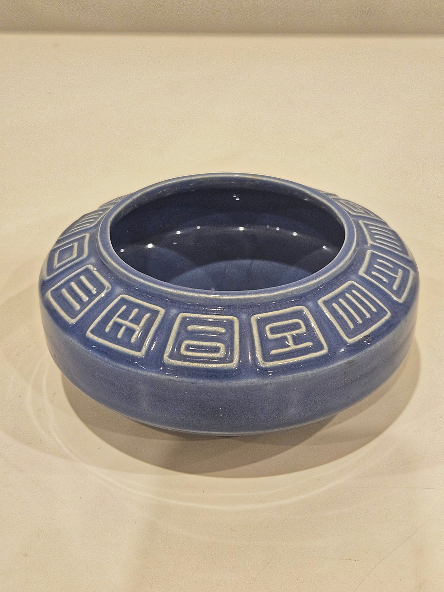 Round ikebana pottery vase arrangement