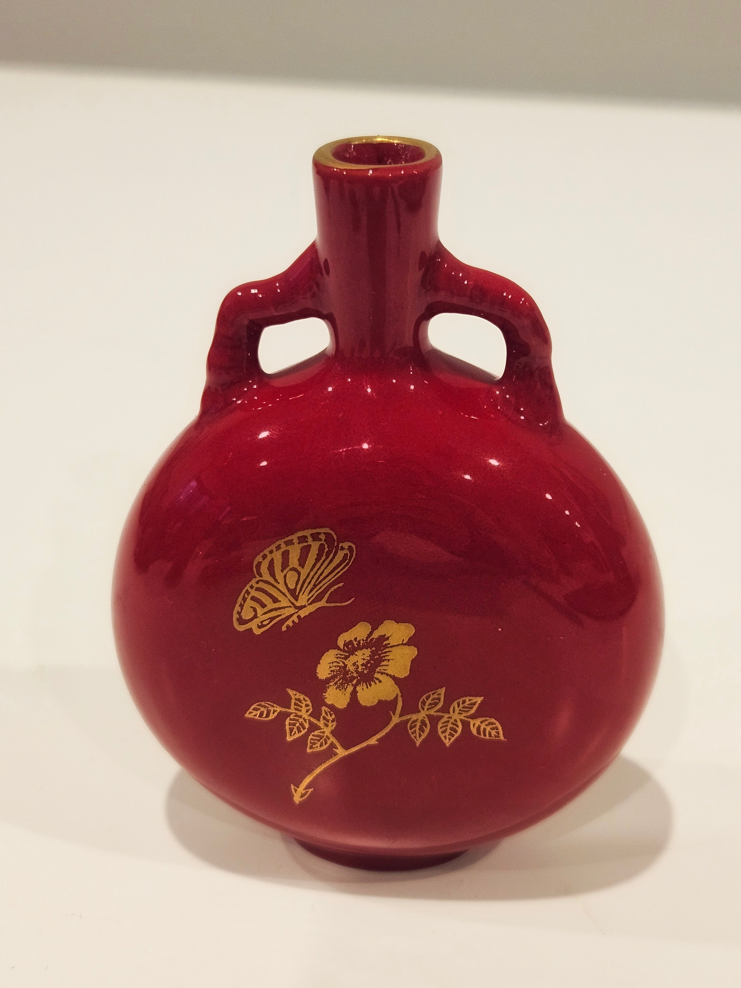 Red and gold bud vase arrangement