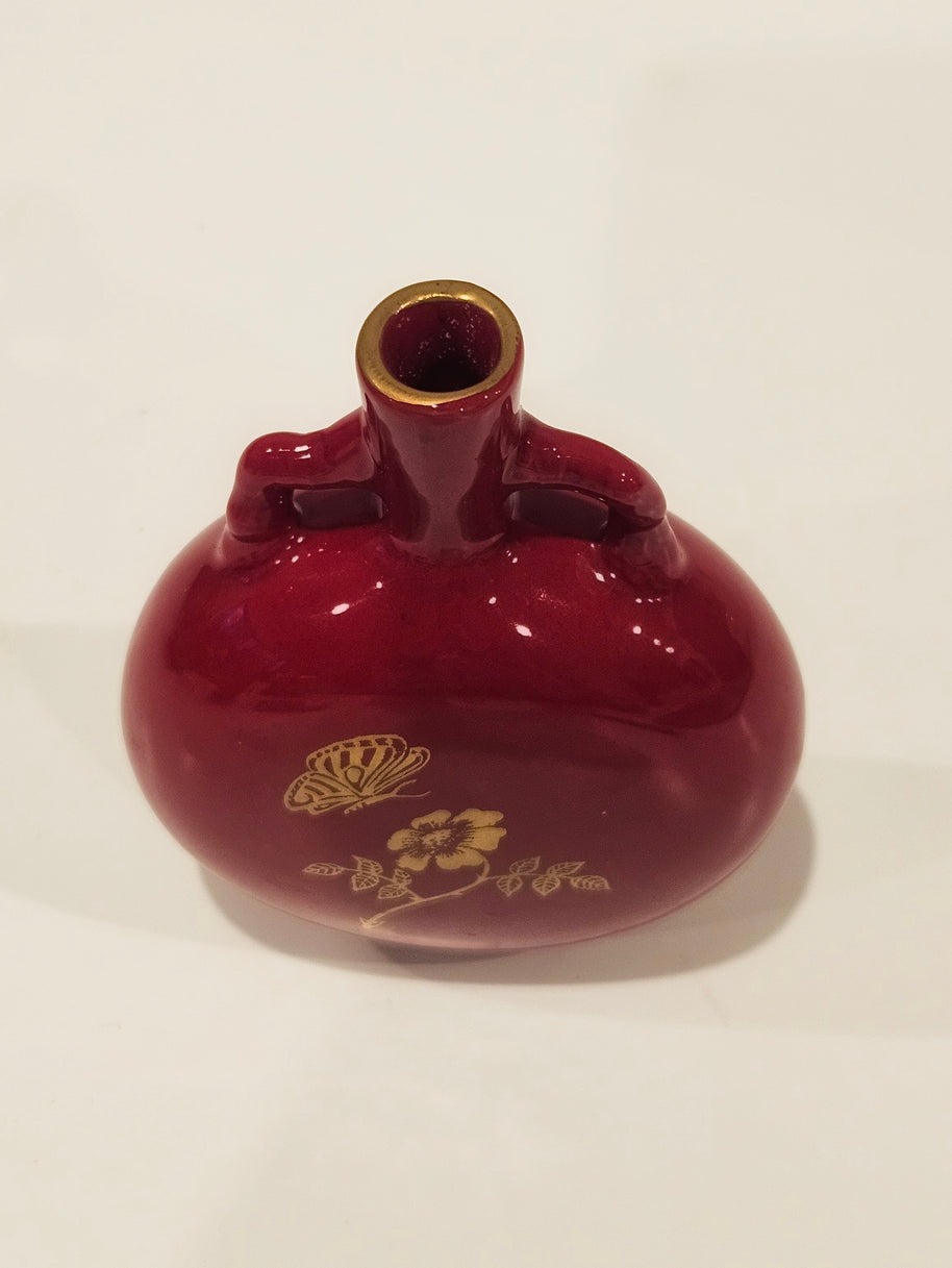 Red and gold bud vase arrangement