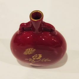 Red and gold bud vase arrangement