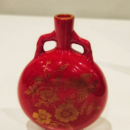 Red and gold bud vase arrangement