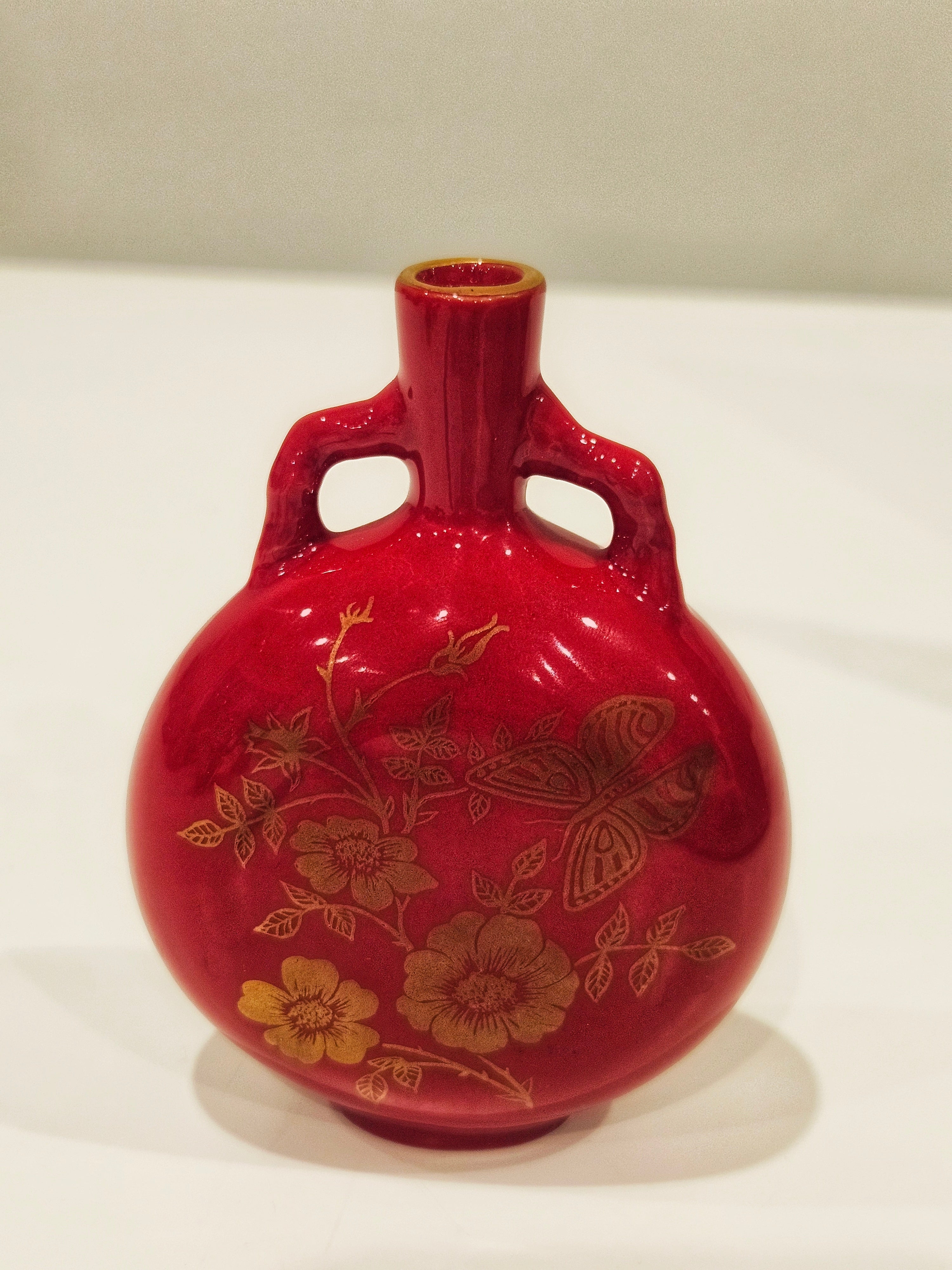 Red and gold bud vase arrangement