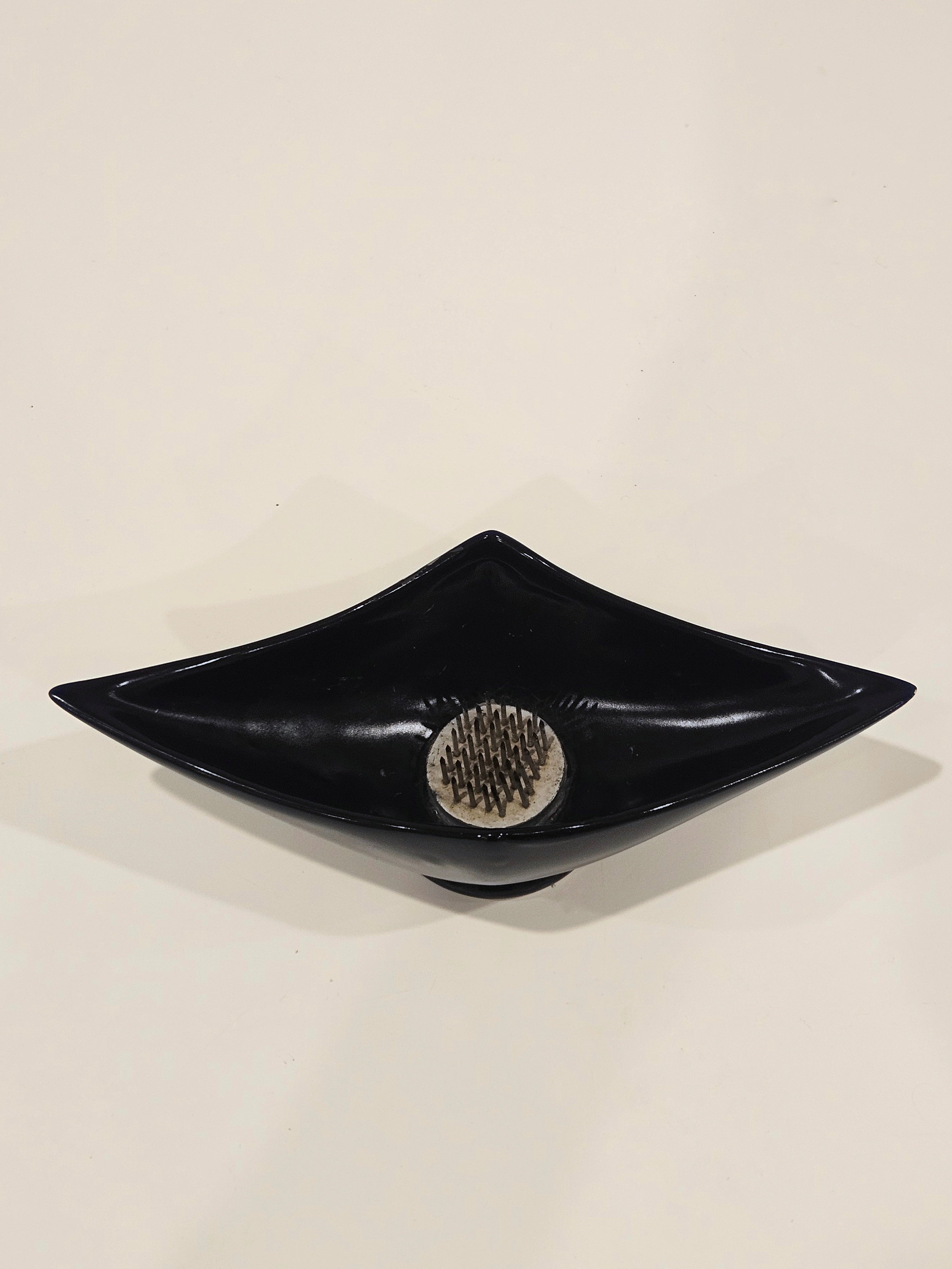 Sleek black ikebana vase arrangement with kenzan