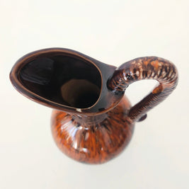 Glossy brown pitcher arrangement