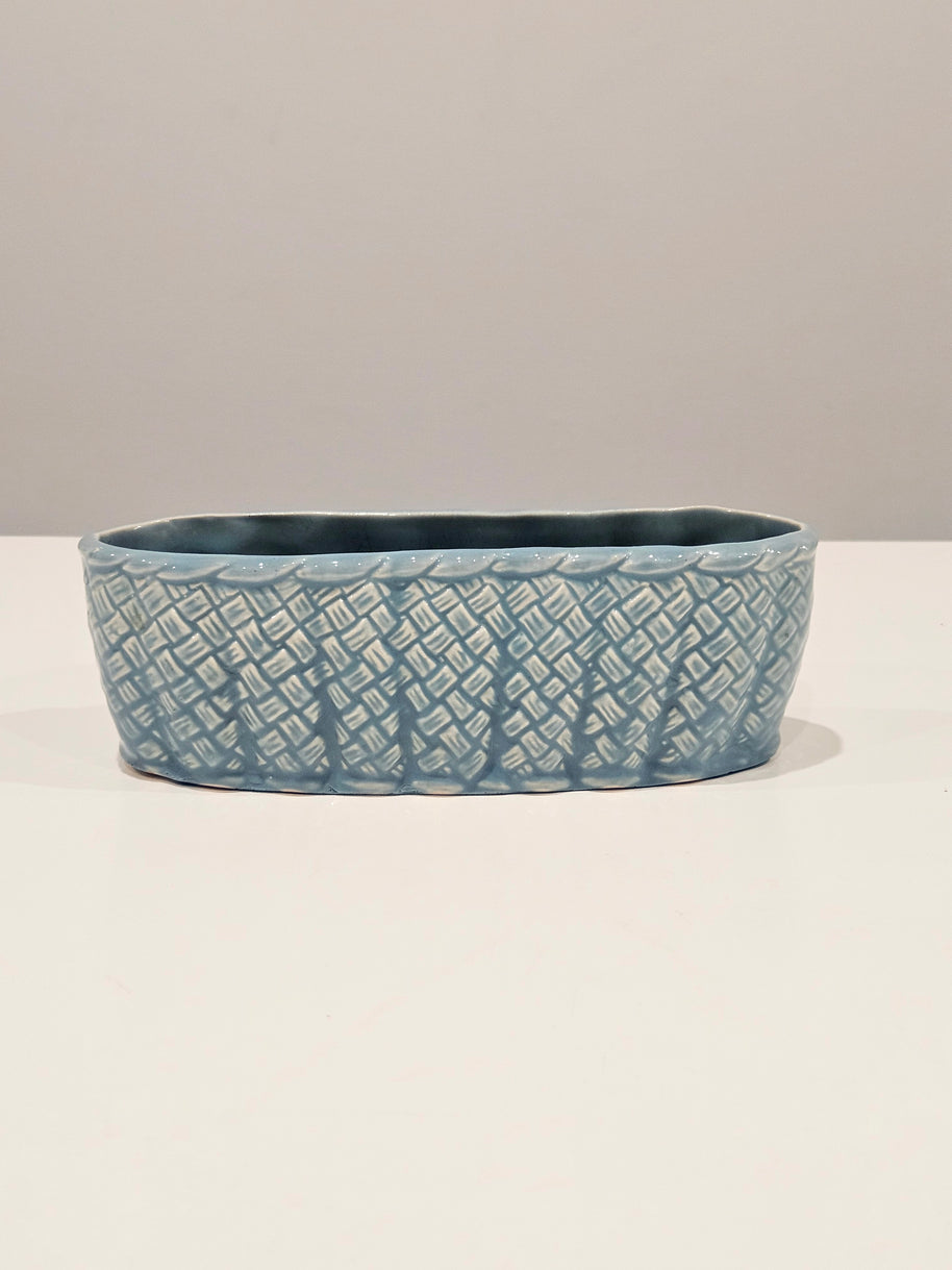 Blue ceramic table centrepiece vase with textured pattern on a white background