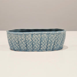 Blue ceramic table centrepiece vase with textured pattern on a white background