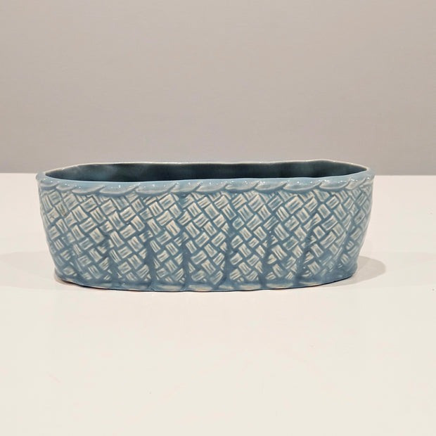 Blue ceramic table centrepiece vase with textured pattern on a white background