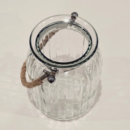 Top down view of a large glass jar with a rope handle
