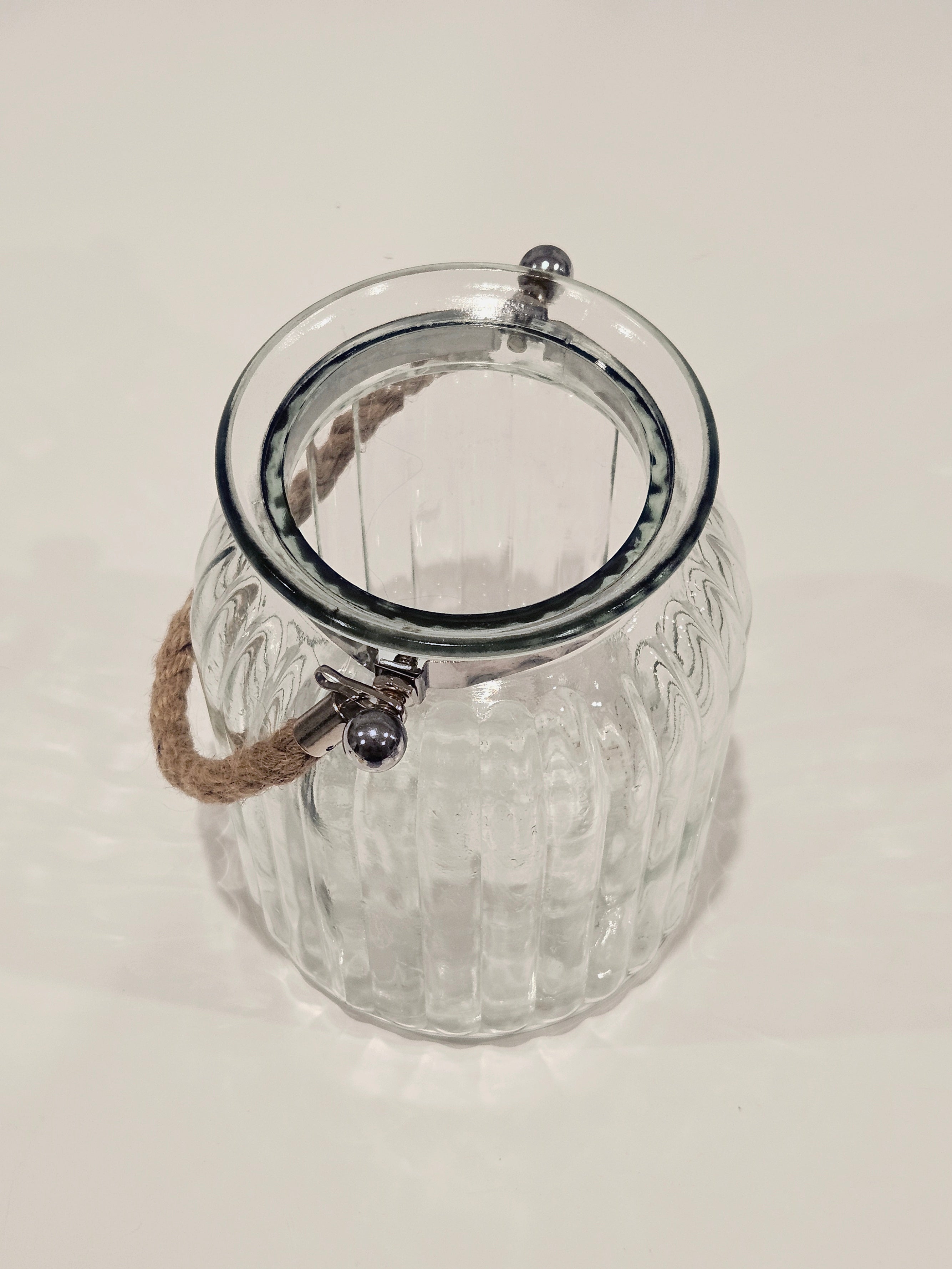 Top down view of a large glass jar with a rope handle