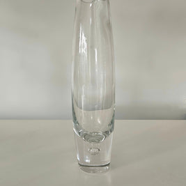 Clear glass vase on a white surface with a white background
