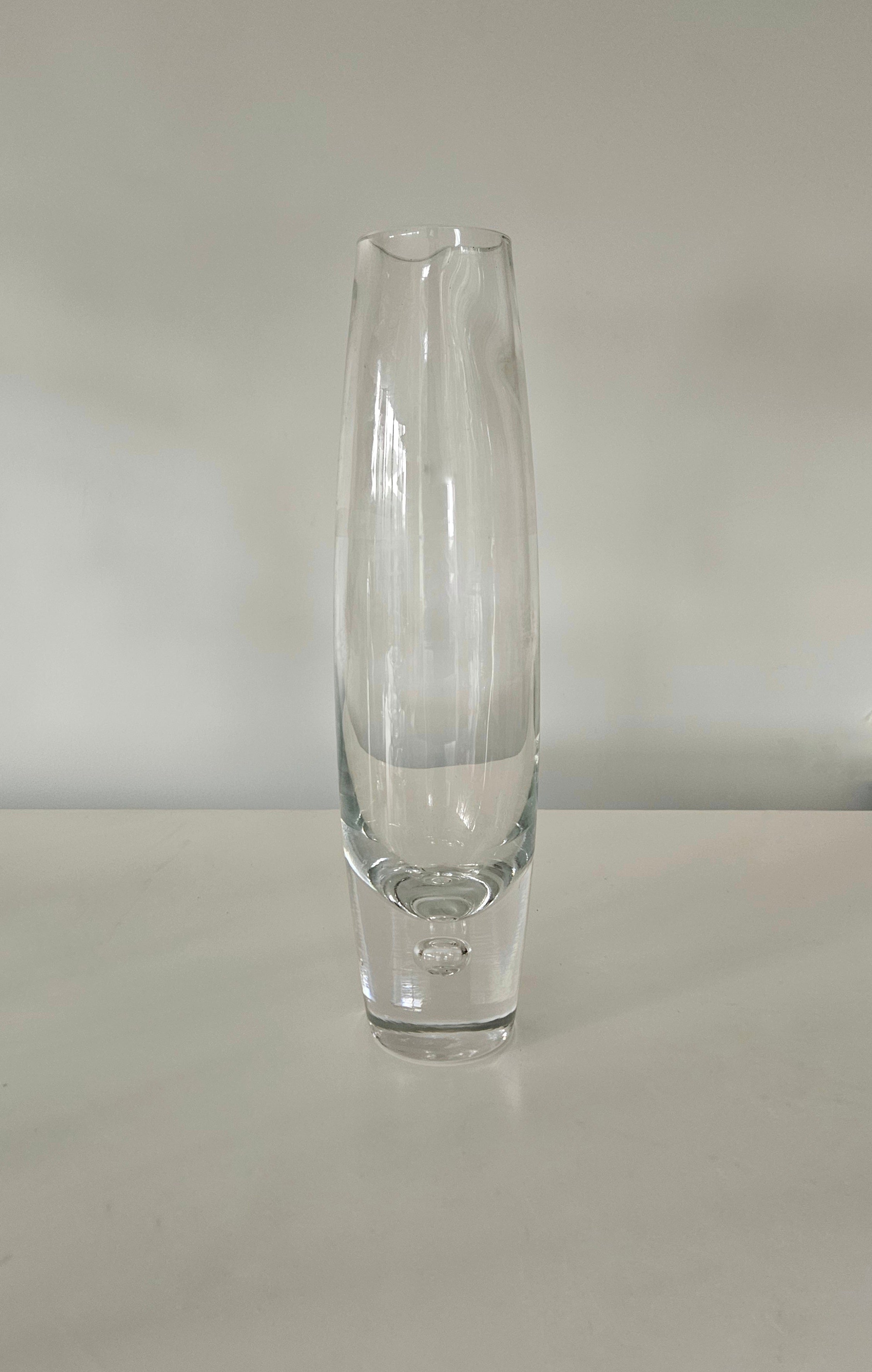 Clear glass vase on a white surface with a white background