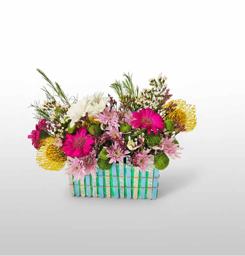 Colourful flower arrangement in a basket on a white background
