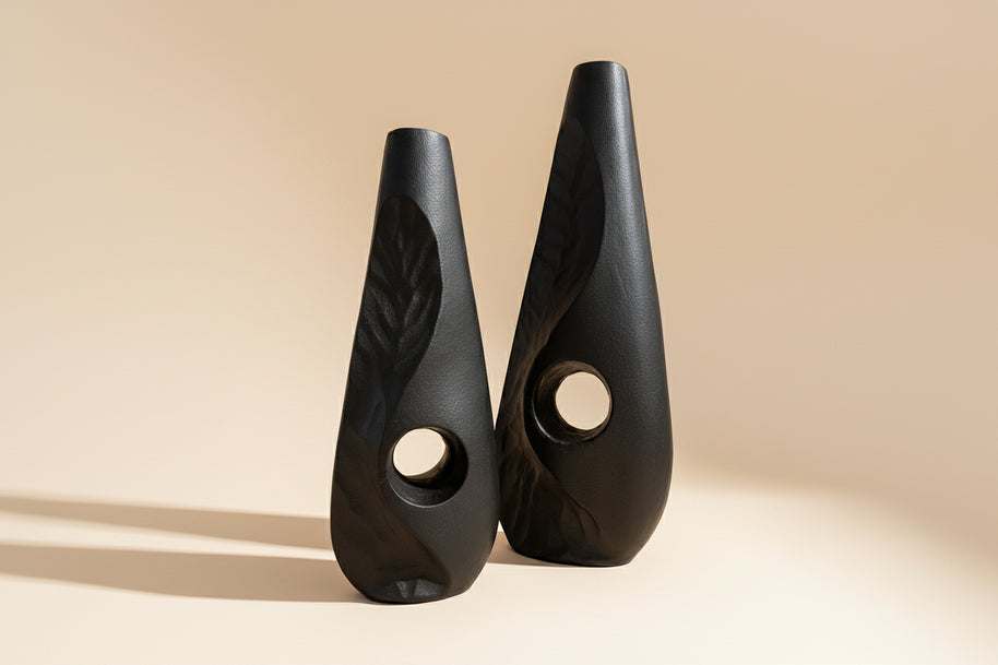 Two black ceramic wedges with textured design on a white background