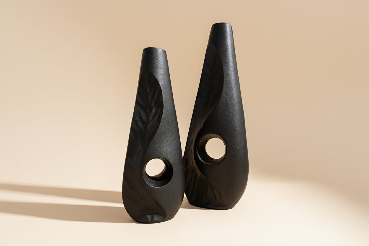 Two black ceramic wedges with textured design on a white background