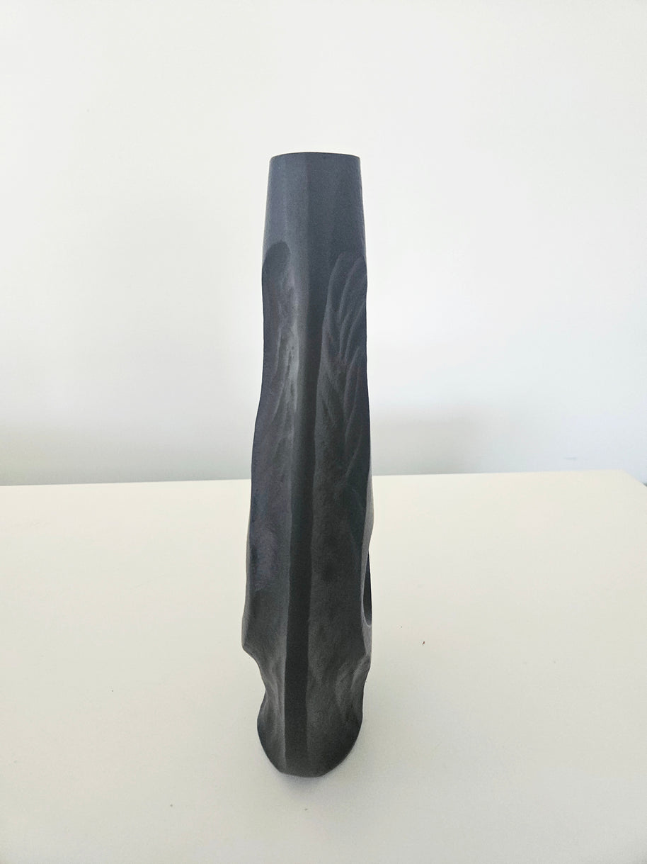 Side view of a black vase