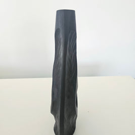 Side view of a black vase