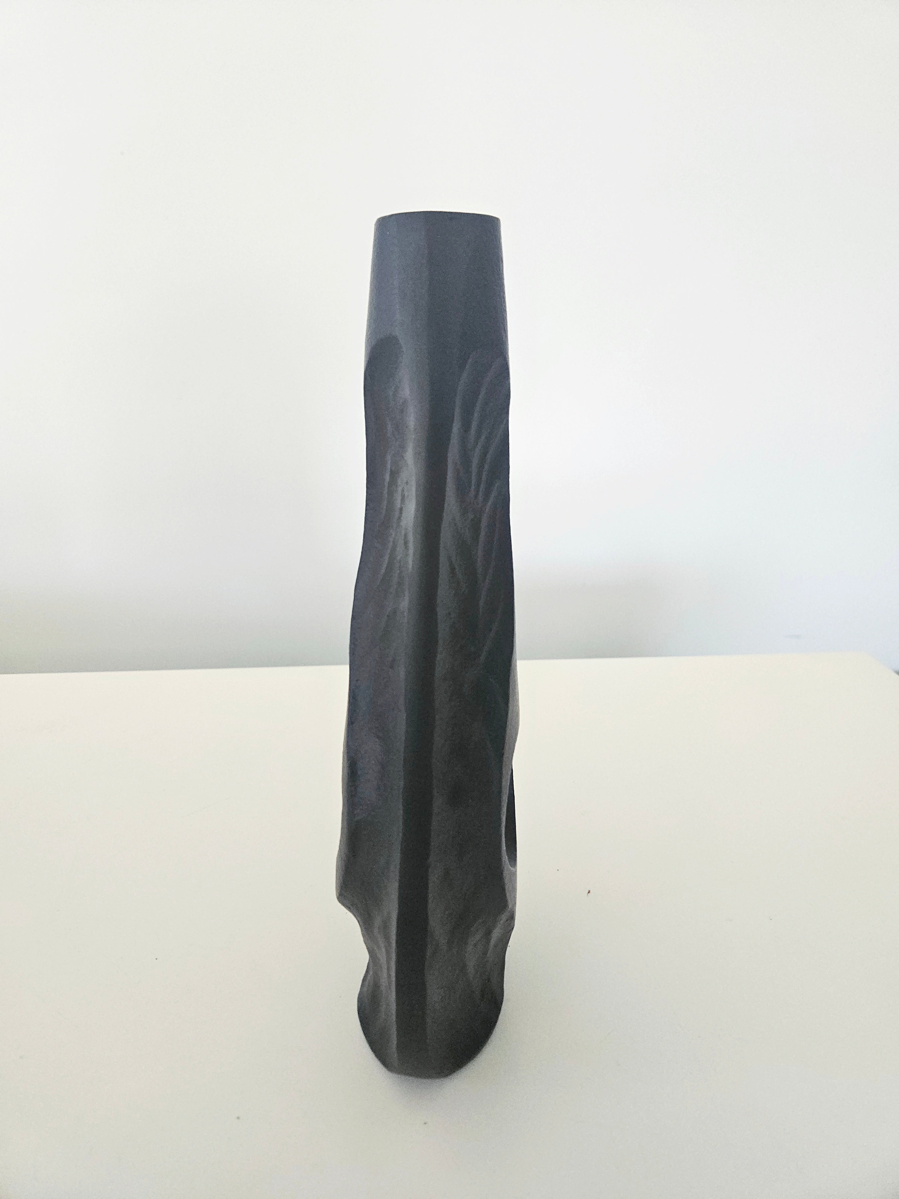 Side view of a black vase
