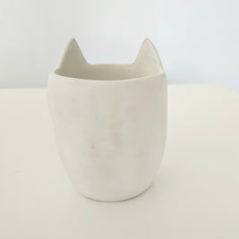 Back view of a pot shaped like a dog