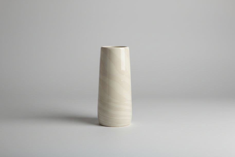 Cylindrical vase with marble-like pattern on a white background