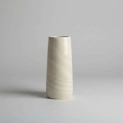 Cylindrical vase with marble-like pattern on a white background