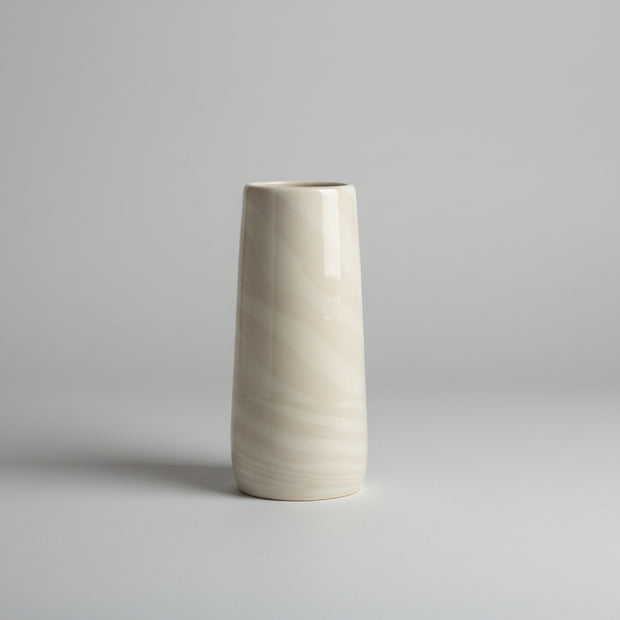 Cylindrical vase with marble-like pattern on a white background