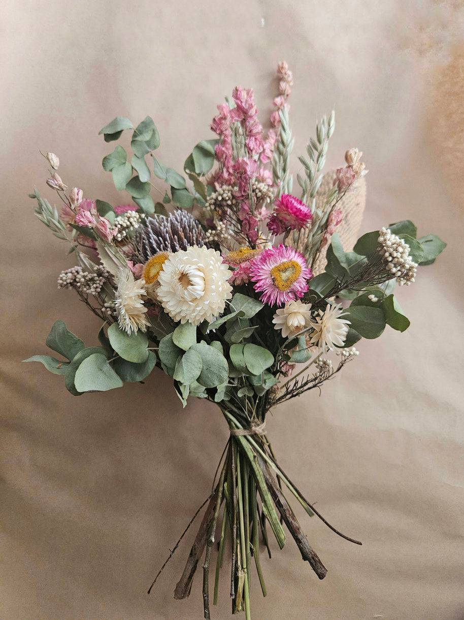 Bouquet of flowers with greenery on a beige background