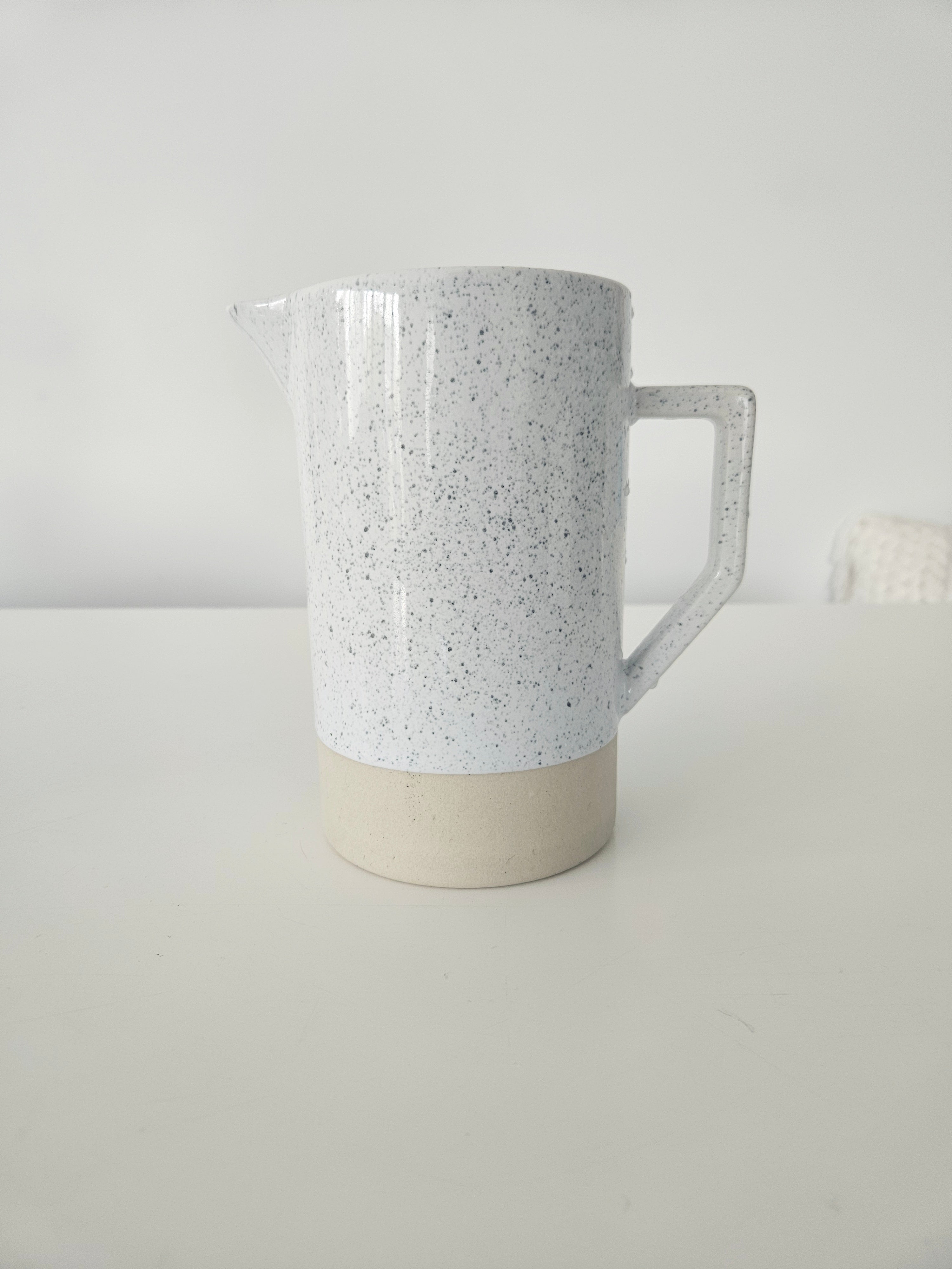 Speckled white and tan pitcher vase arrangement