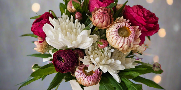 Bouquet of flowers in a white vase with a soft, blurred background