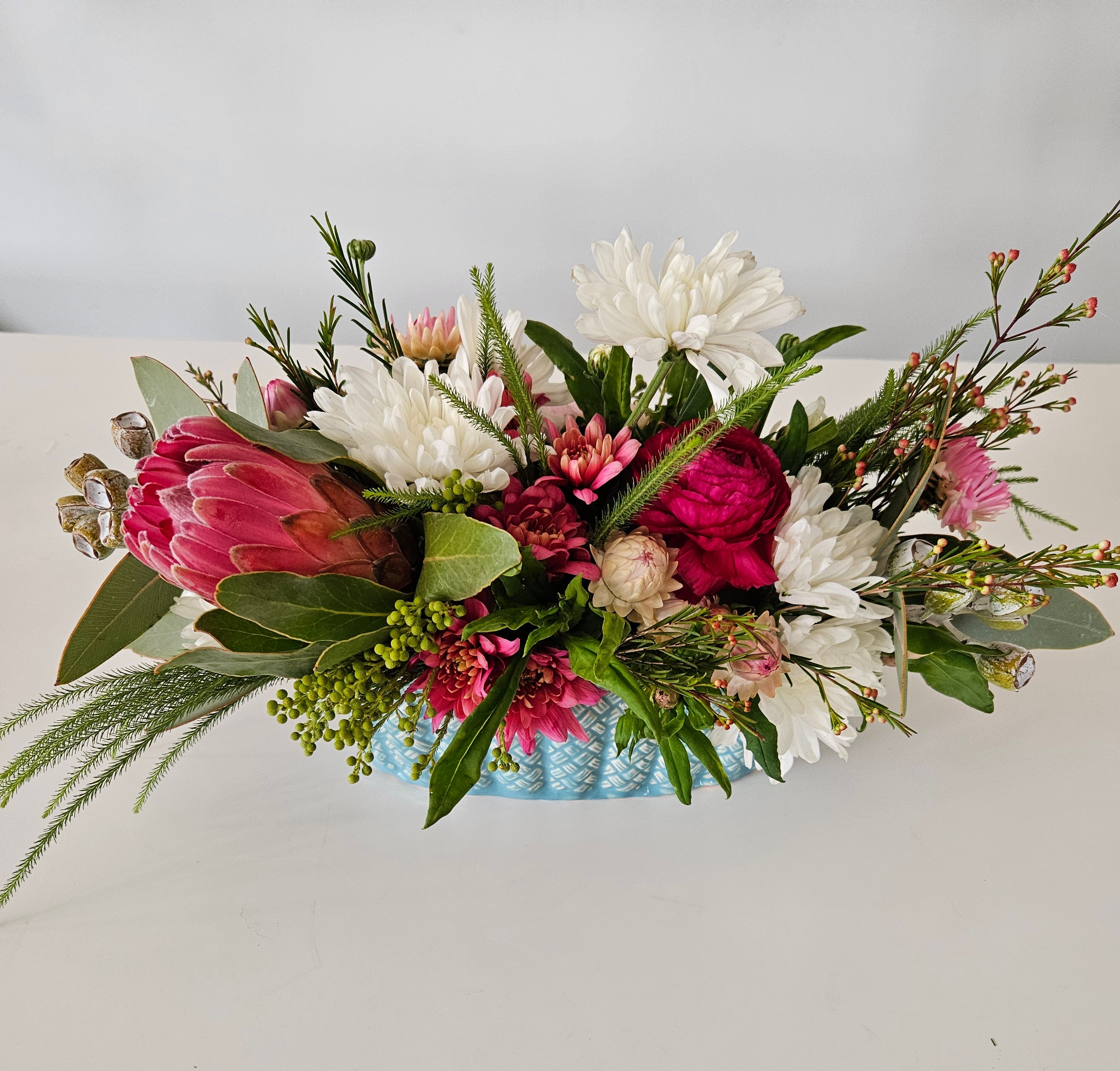 Pastel blue table centrepiece vase arrangement