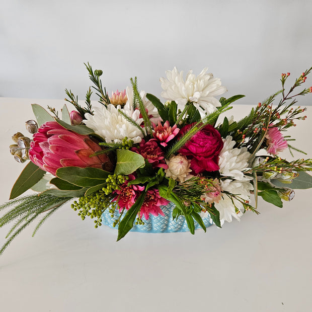 Pastel blue table centrepiece vase arrangement