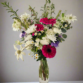 Tall elevated bubble glass vase arrangement