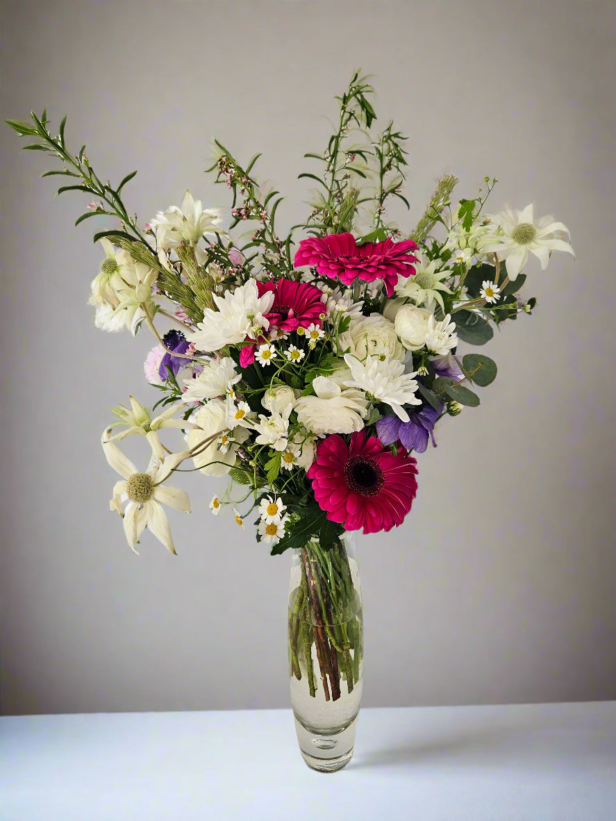 Tall elevated bubble glass vase arrangement