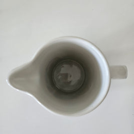 Top down view of a blue and white striped jug