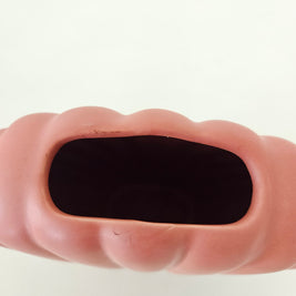 Top down view of a peach ceramic shell vase