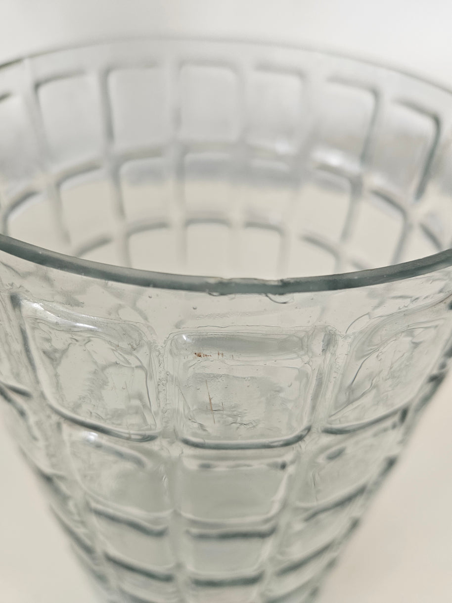 Close-up of a textured glass vase on a light background