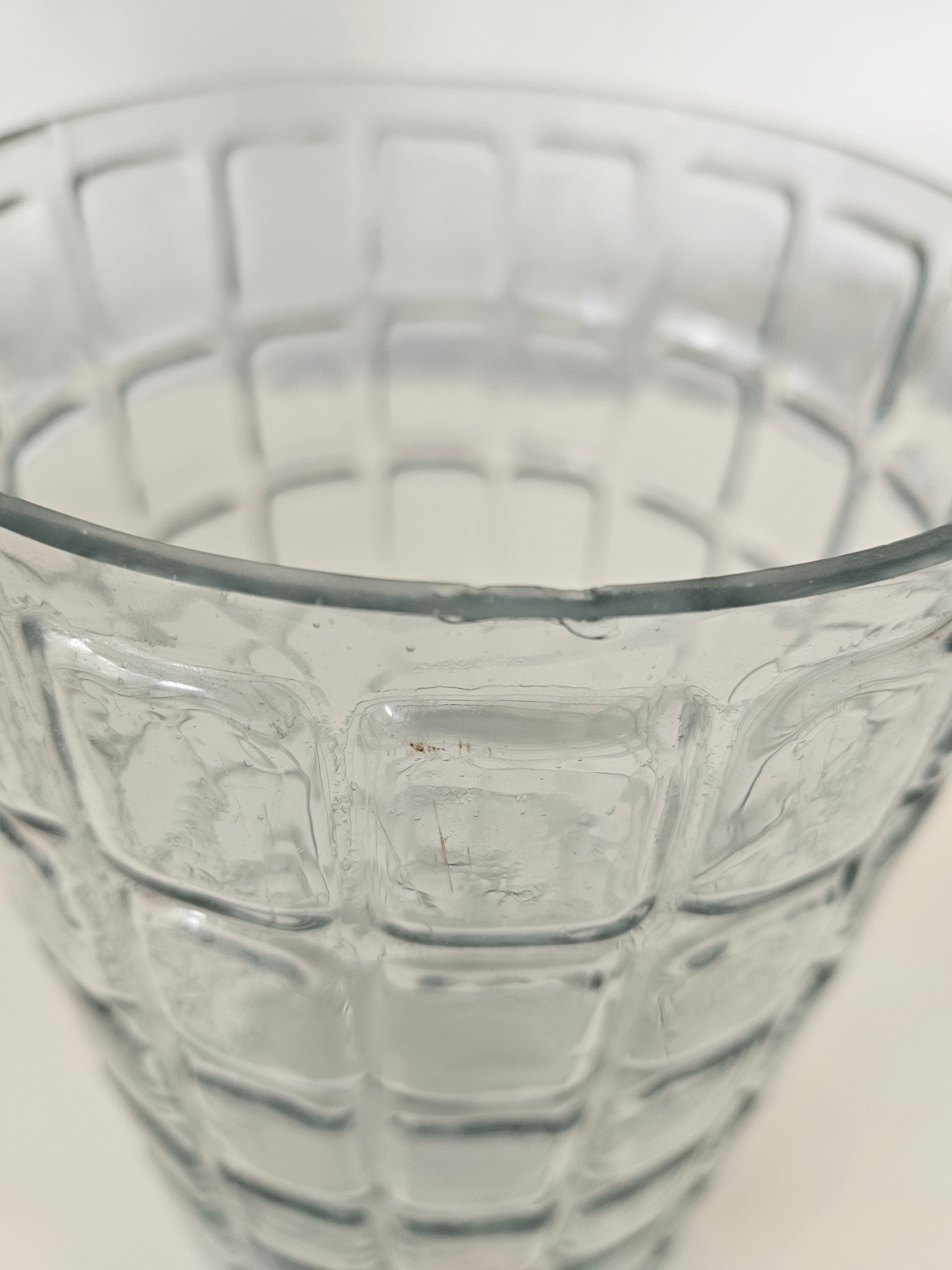 Close-up of a textured glass vase on a light background