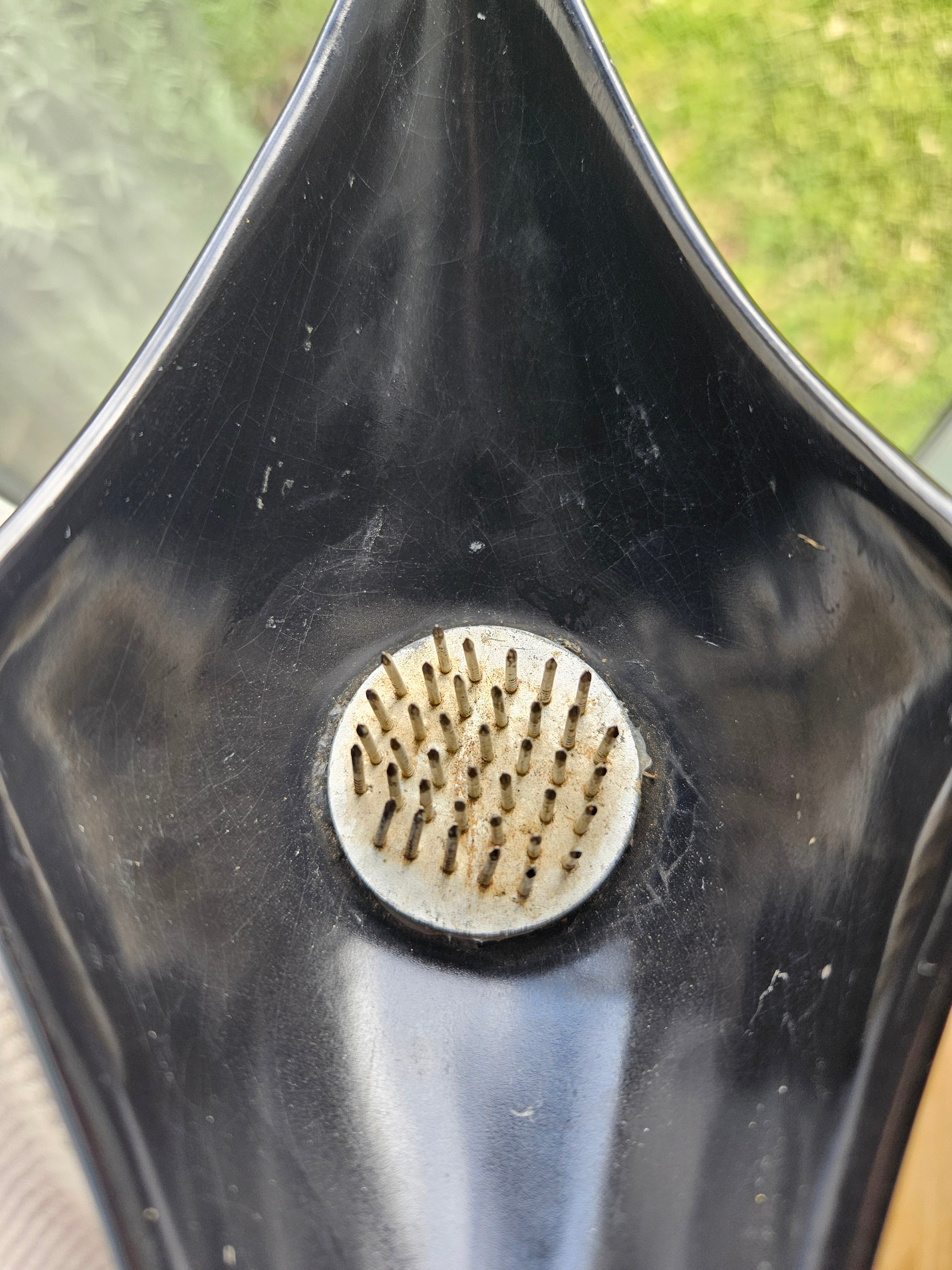 Top down view of ikebana vase with a kenzan in the middle