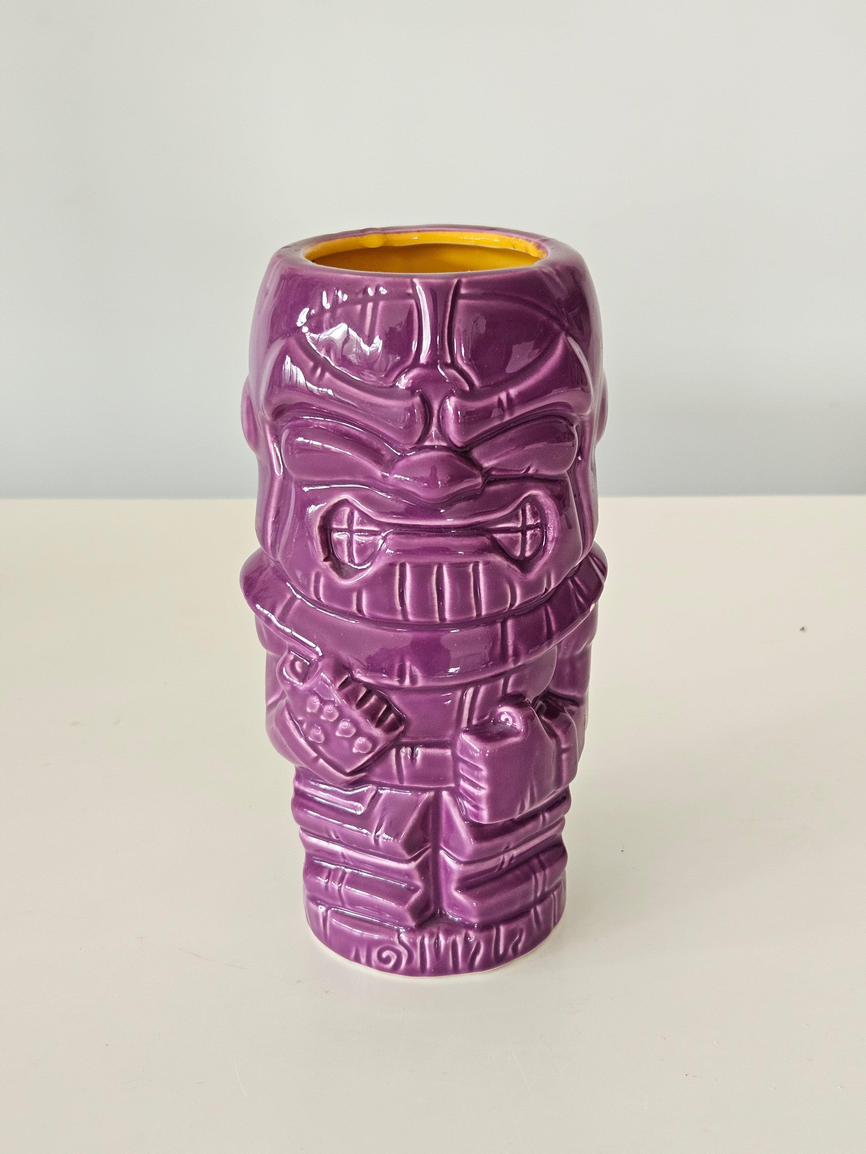 Purple tiki style Thanos vase on a white background