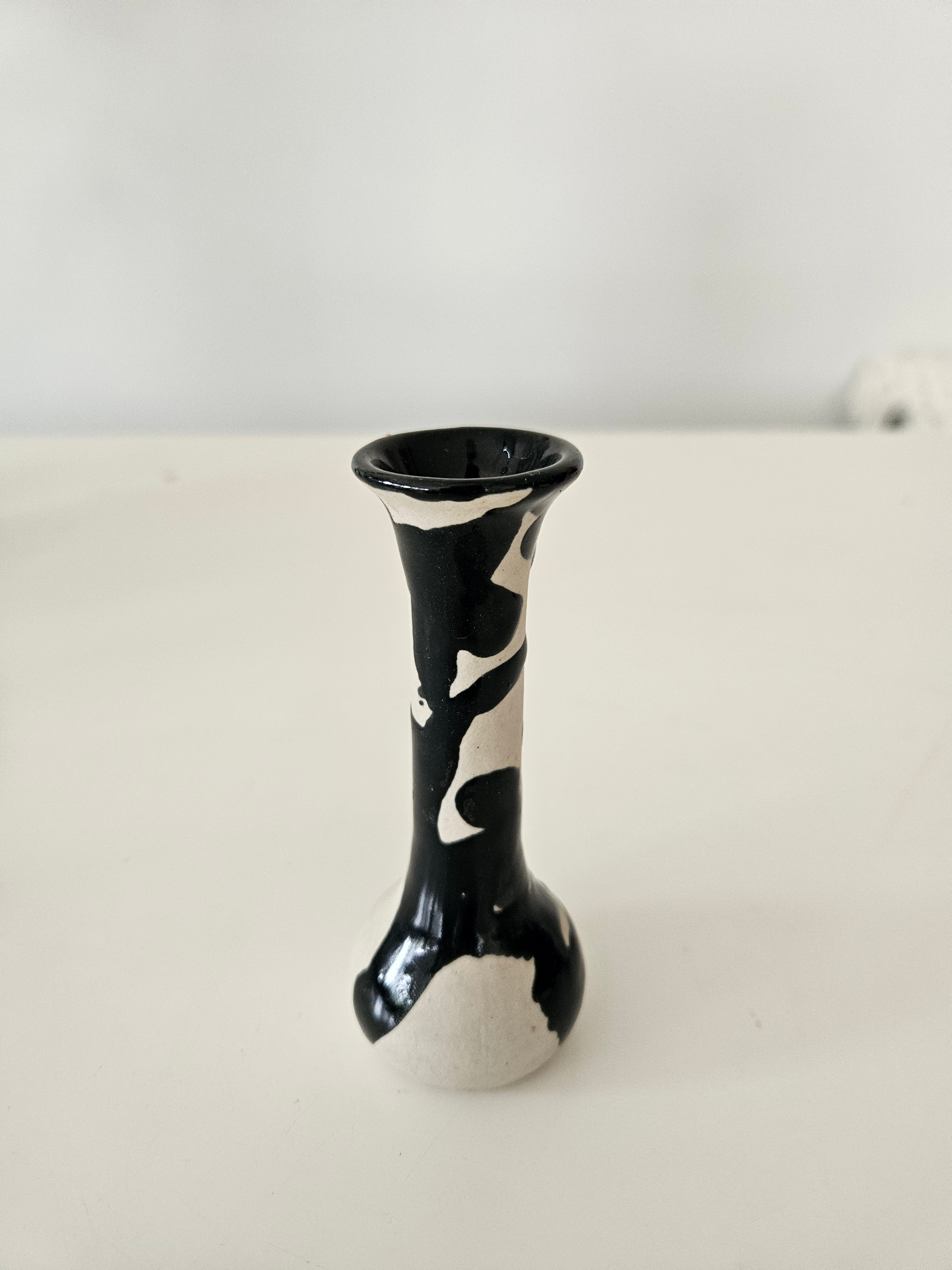 Black and white ceramic bud vase on a white background