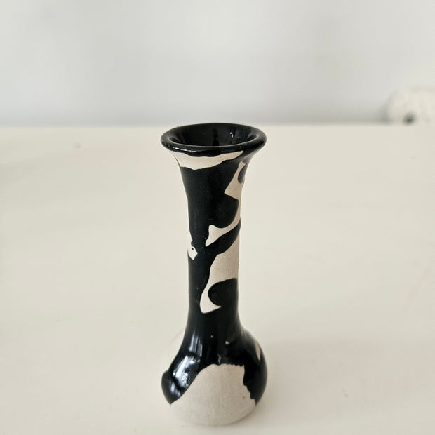 Black and white ceramic bud vase on a white background