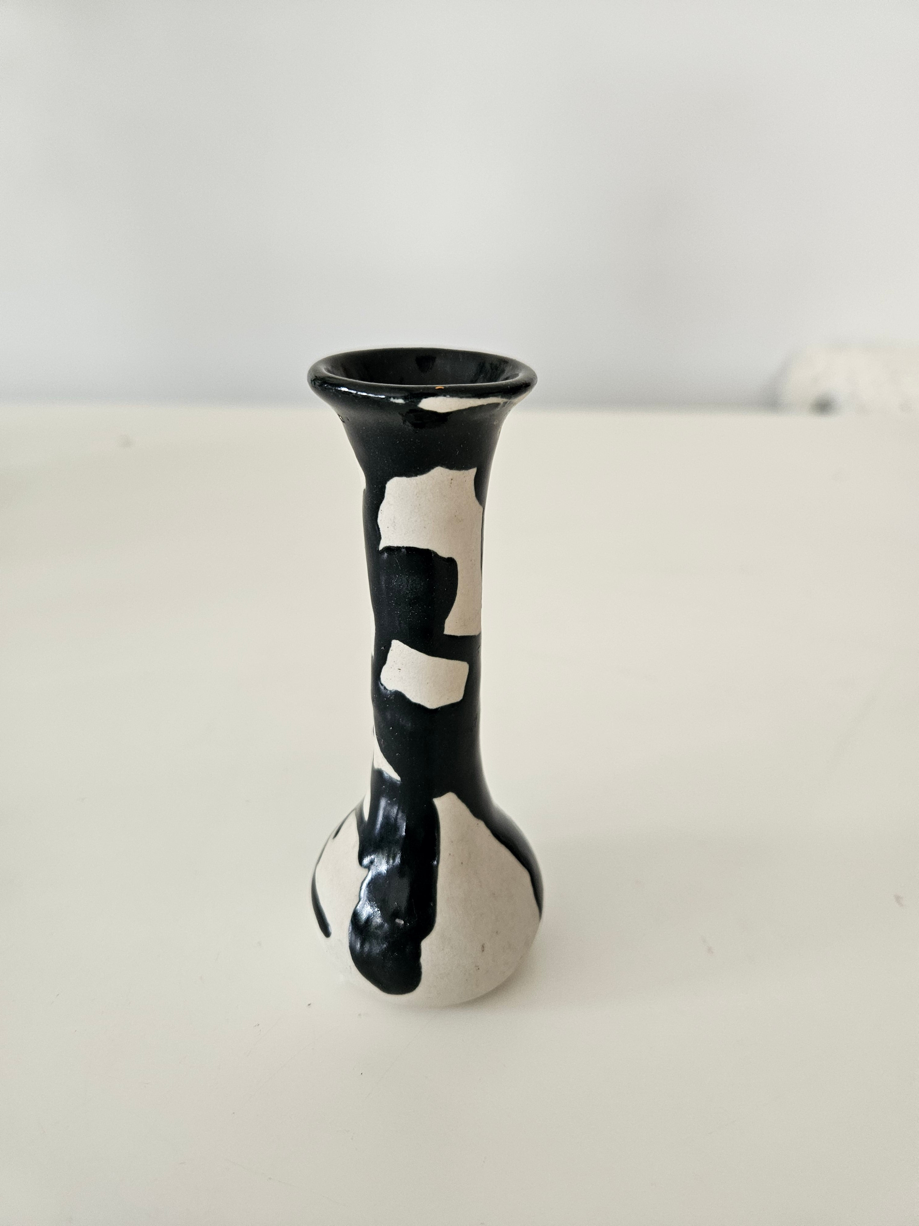 Black and white patterned bud vase on a white background