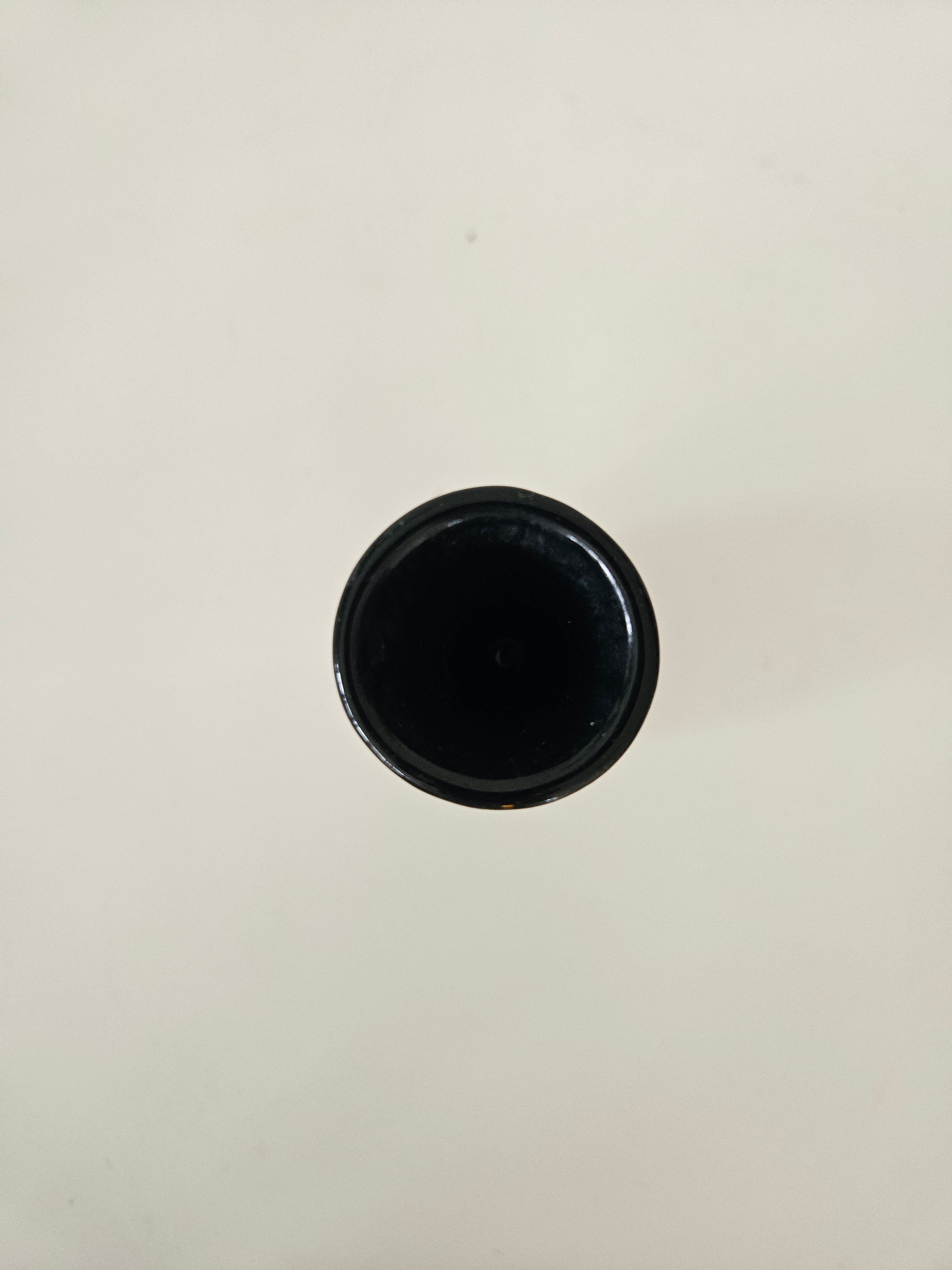 Top down view of a black vase on a white background