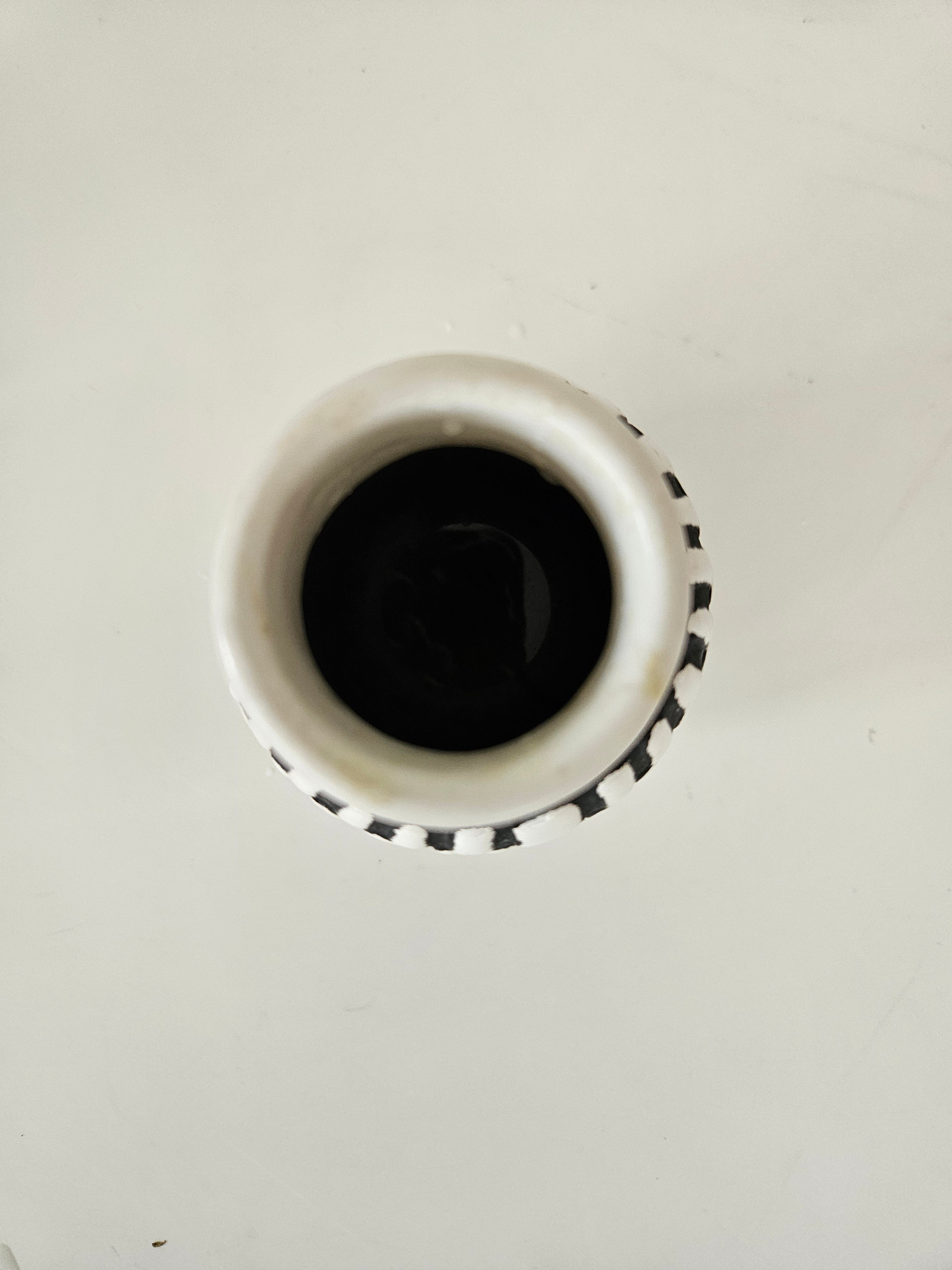 Top down view of a black and white ceramic vase