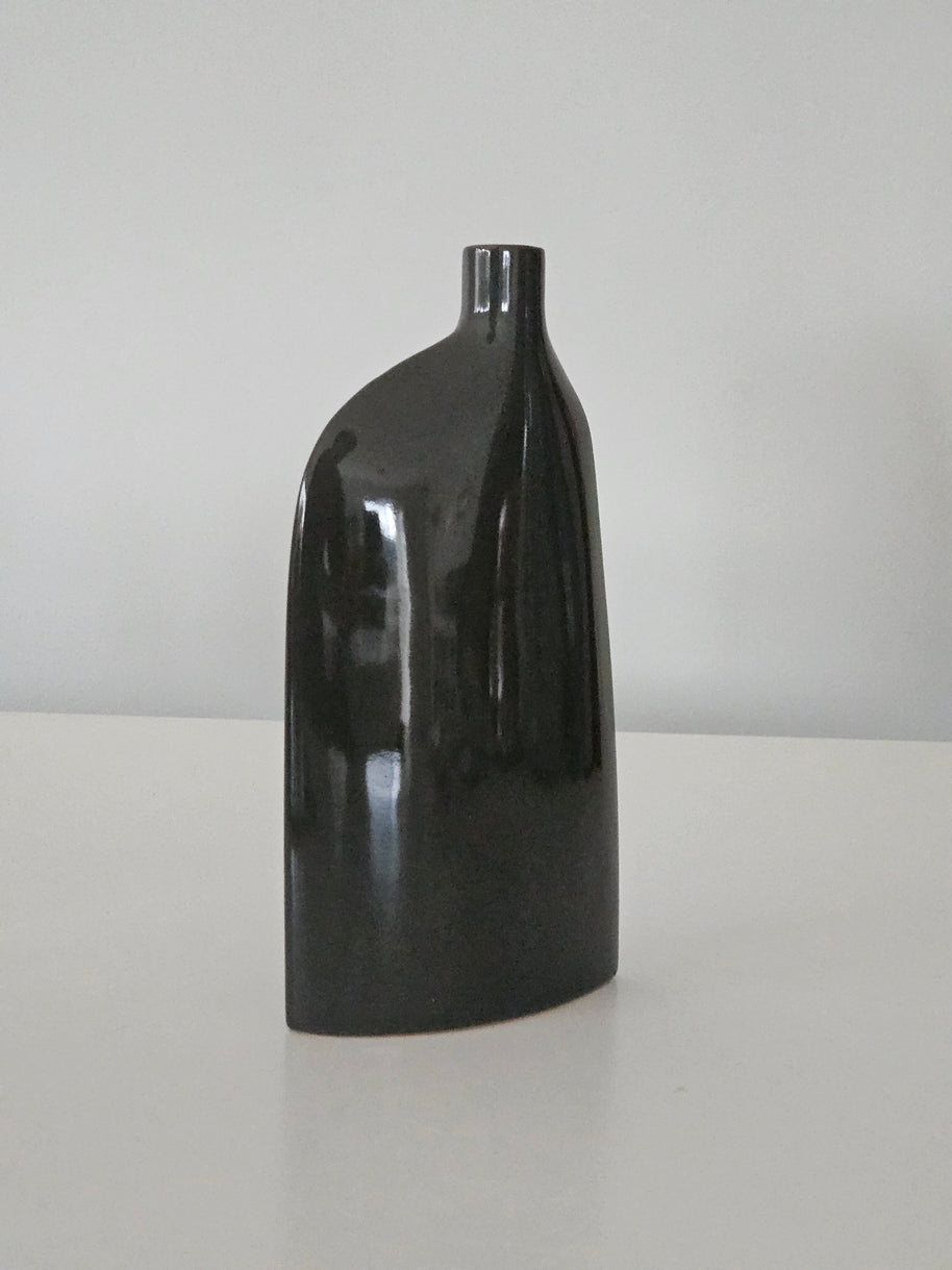 Side view of a black ceramic vase