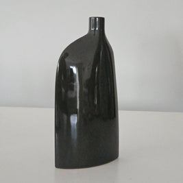 Side view of a black ceramic vase