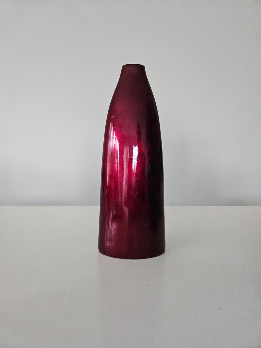 Glossy red-brown cylindrical vase on a white background