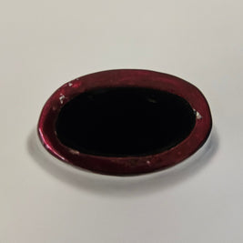 Top down view of a red-brown ceramic vase on a white background