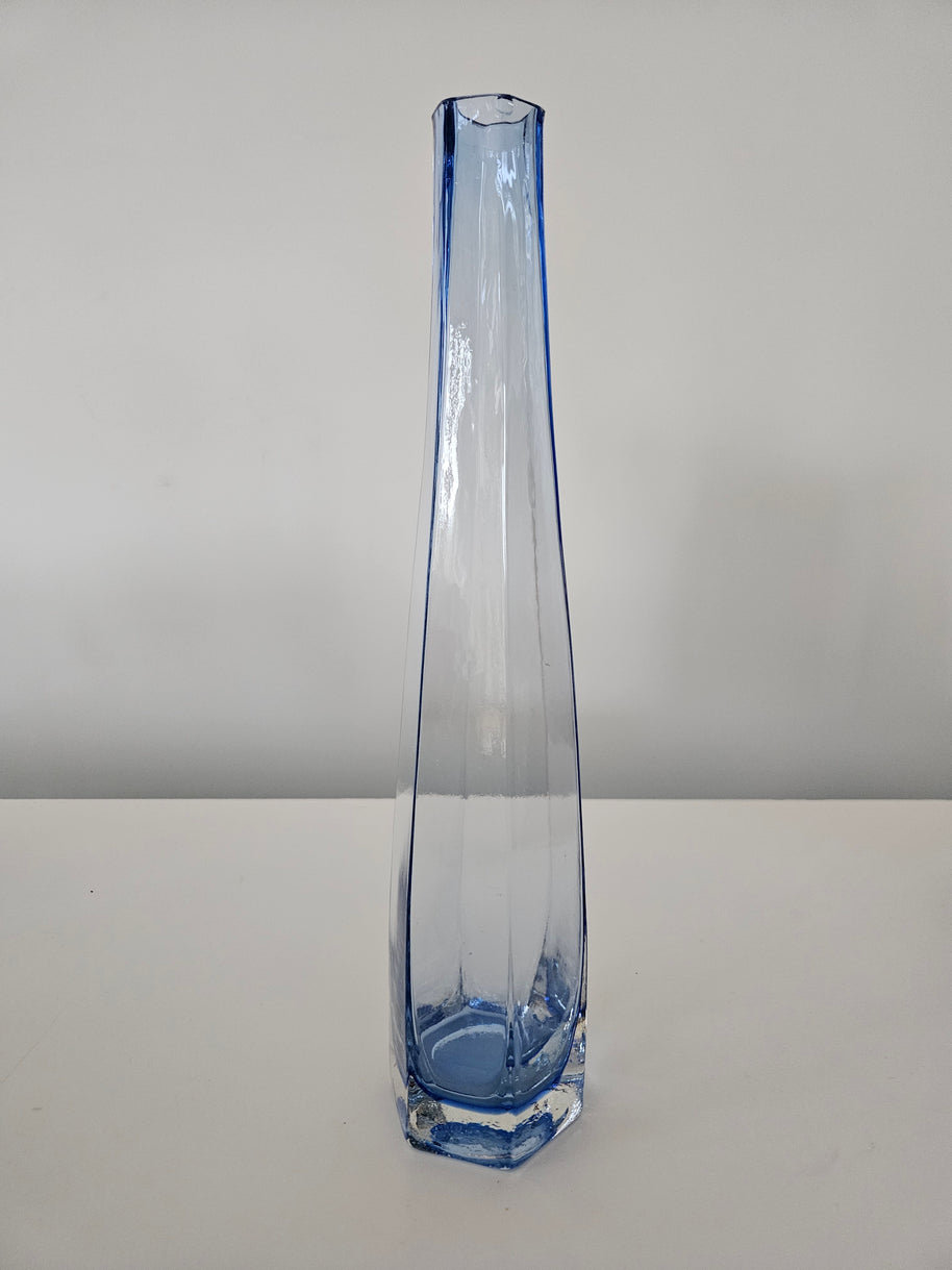 Clear glass vase with blue accent on a white background